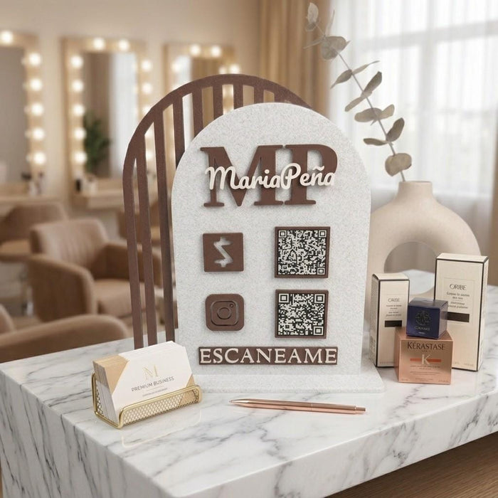 Custom QR code sign with MariaPeña MP logo, two QR codes, payment and Instagram icons, brown and white, on salon counter