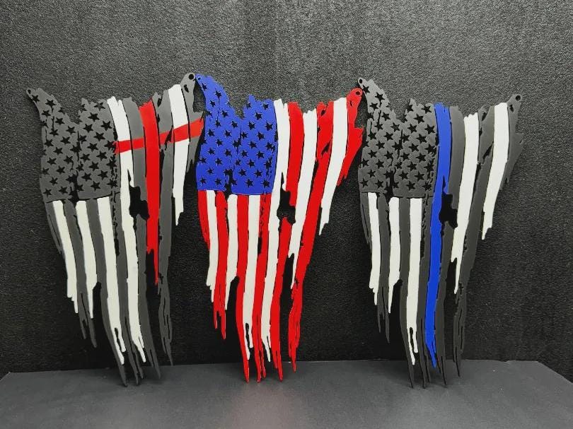 Three tattered American flag wall decor pieces: red-line, full-color, and blue-line versions on a dark background