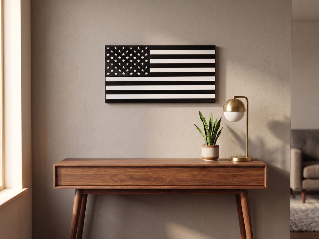 Personalized thin line flag in black and white hung above a wood console table with plant and lamp