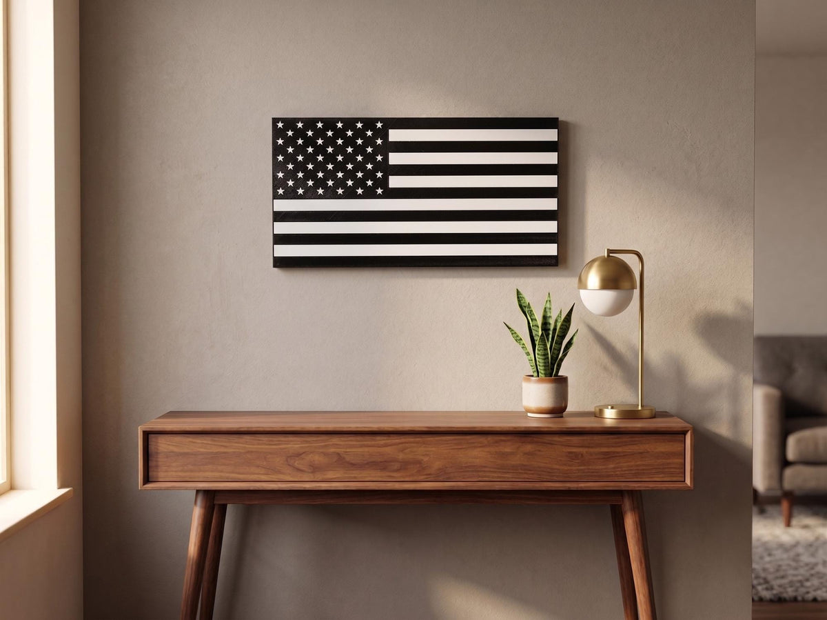 Personalized thin line flag in black and white hung above a wood console table with plant and lamp
