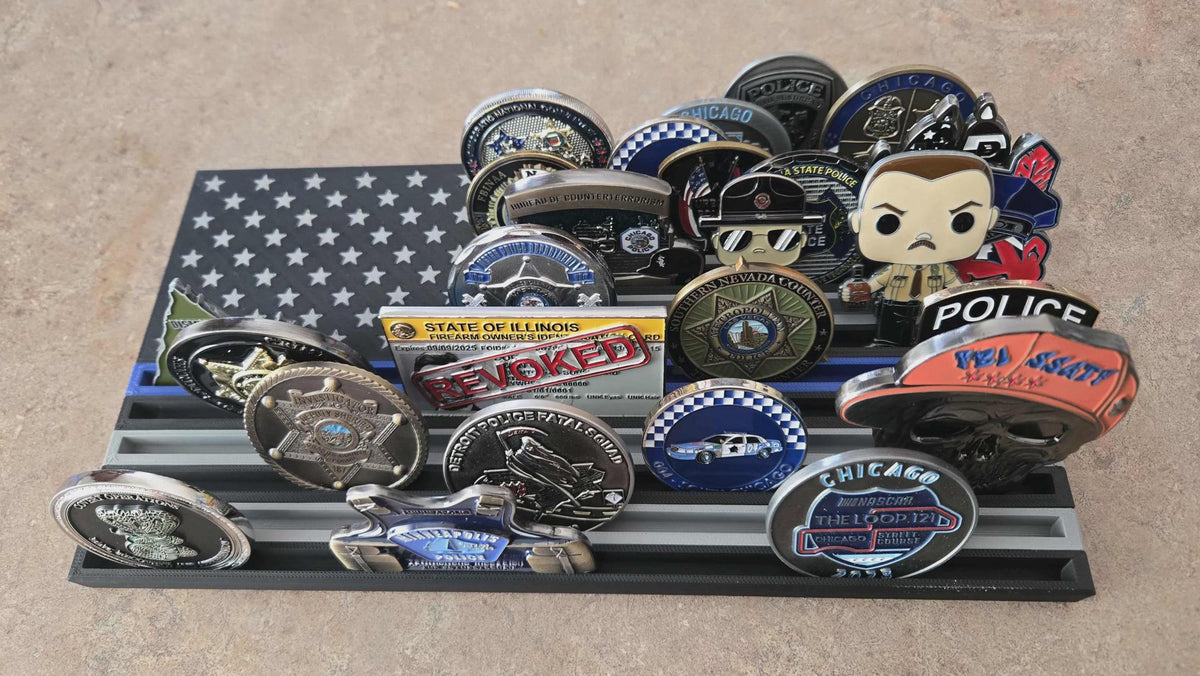 Thin Line Flag Challenge Coin Display holding police and Chicago challenge coins on a tiered black and gray flag rack