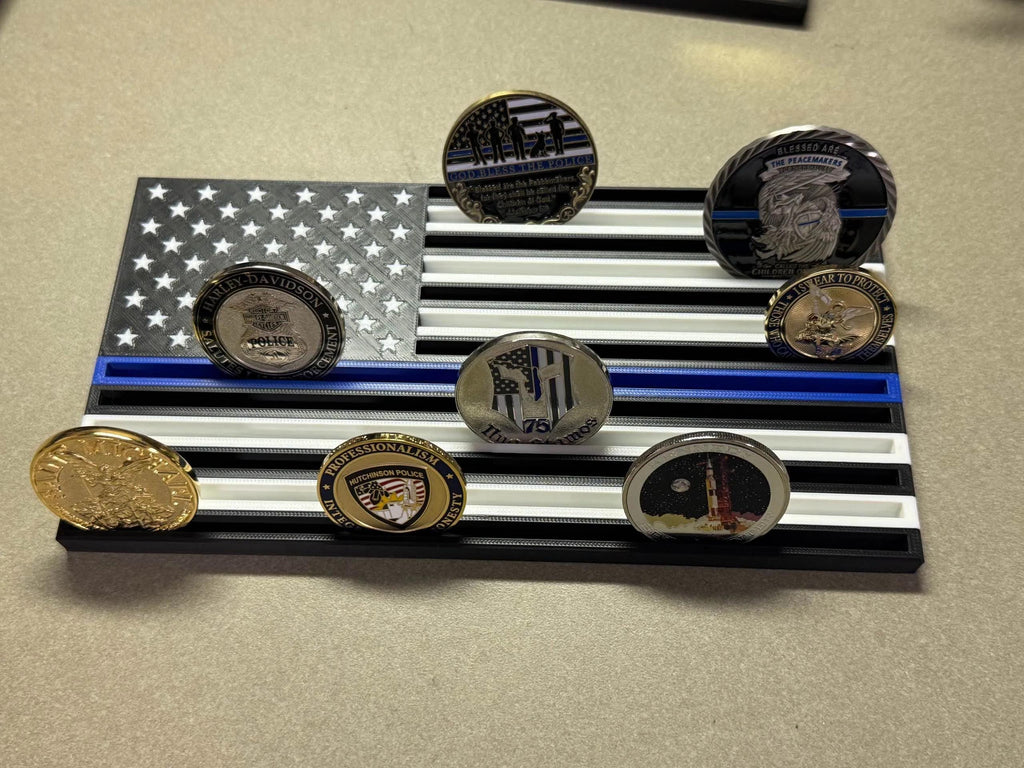 Thin Line Flag Challenge Coin Display in black, white and blue holding eight challenge coins on a tabletop