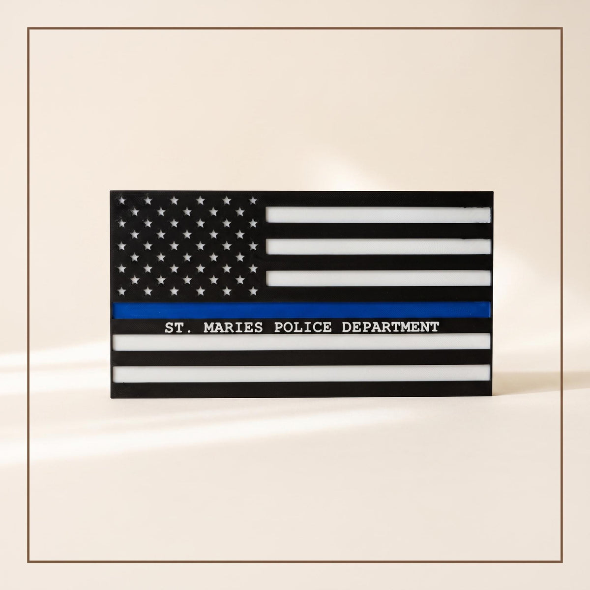 Personalized thin blue line flag reading "St. Maries Police Department" on a black and white flag with blue stripe, cream bac