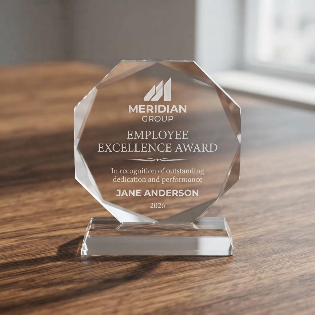 Personalized crystal award with Meridian Group logo, Employee Excellence Award text and Jane Anderson, on a wood table
