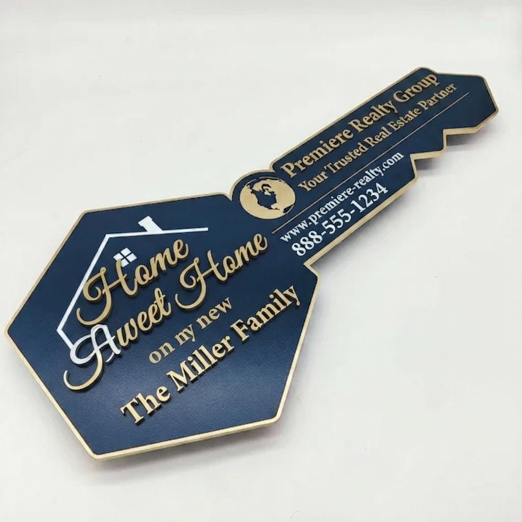 Key-shaped realtor sold sign in navy and gold reading Home Sweet Home, The Miller Family, Premiere Realty Group