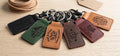 Leather logo keychains in six colors with sample logos like Highland Trails, Coffee & Co. and Artisan Mercantile