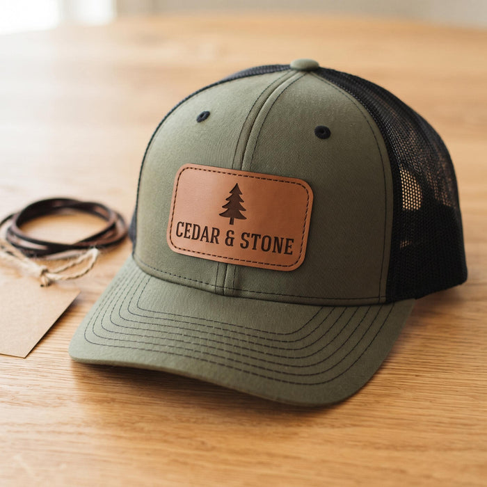 Custom leather patch hat, olive green trucker snapback with laser engraved tan leatherette patch logo