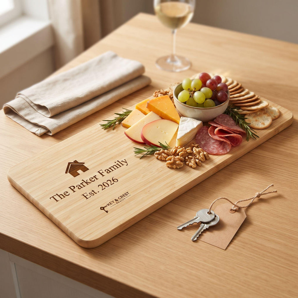 Personalized charcuterie board engraved with family name and realtor logo, styled with cheese and grapes